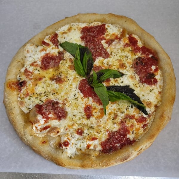 Bella Donna Pizzeria's Margherita pizza, topped with fresh basil, mozzarella, and tomato sauce.